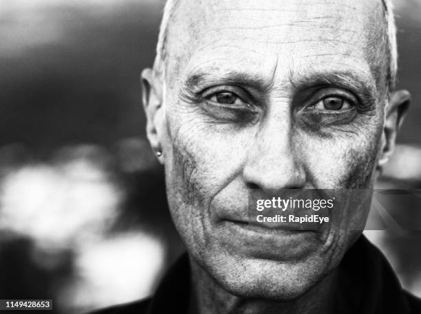 ominous looking senior man stares at camera - psychopathy stock pictures, royalty-free photos & images