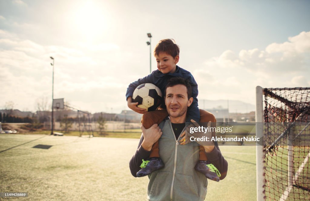 Father and son on a soccer court