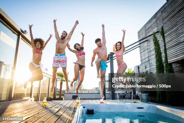 friends partying on a rooftop - hot tub party stock pictures, royalty-free photos & images