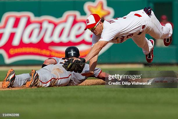 Ryan Theriot of the St. Louis Cardinals attempts to pick off Aaron Rowand of the San Francisco Giants at second base at Busch Stadium on May 30, 2011...
