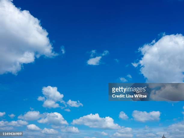 clouds in a bright blue sky - clear sky stock-fotos und bilder