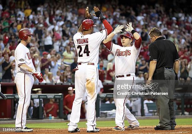 Miguel Montero of the Arizona Diamondbacks high-fives teammates Chris Young and Stephen Drew after Montero hit a three-run home run against the...