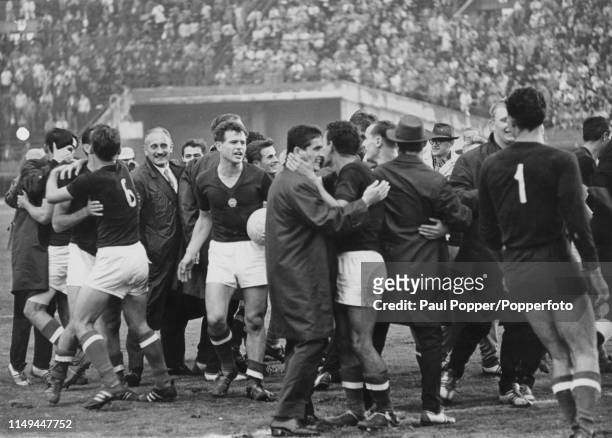 Jubilant Hungarian football fans run on to the pitch to congratulate thier players after Hungary beat Czechoslovakia 2-1 in the final of the football...