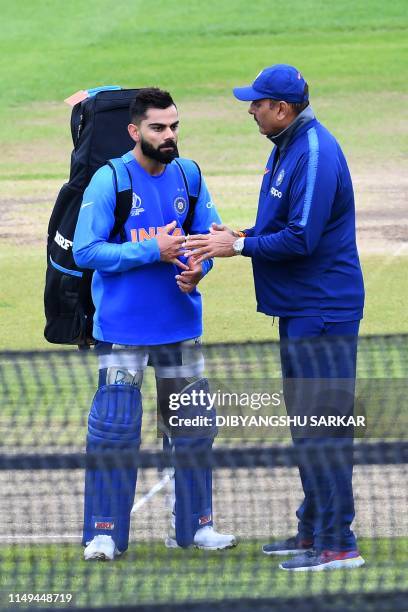 India's captain Virat Kohli talks with India's head coach Ravi Shastri during a nets training session at Trent Bridge in Nottingham, central England,...