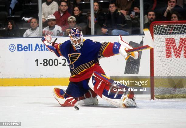 Goalie Grant Fuhr of the St. Louis Blues makes the save during an NHL game against the New Jersey Devils in 1998 at the Contenental Airlines Arena in...