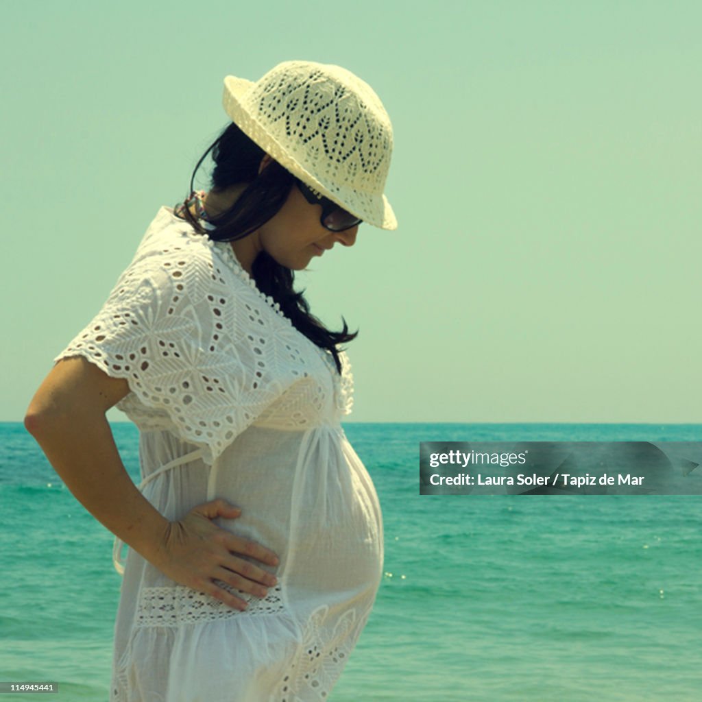 Pregnant woman looking down