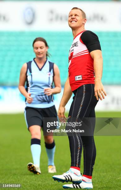 Ryan O'Keefe conducts some goal kicking practice with members of the NSW/ACT AFL Women's team before a Sydney Swans AFL training session at Sydney...