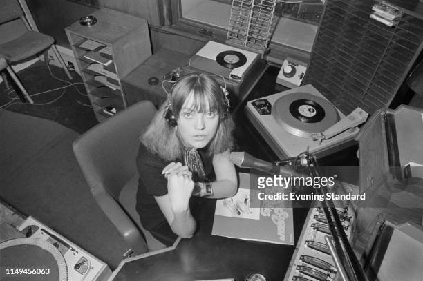 English radio and television broadcaster and disc jockey Annie Nightingale with record 'Sugar Sugar' by the Archies, in a radio recording studio, UK,...