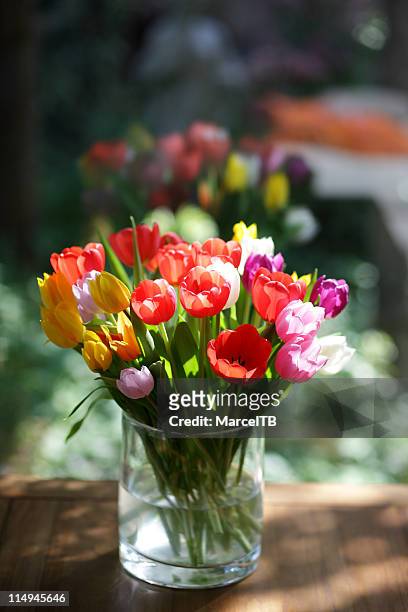 bringing spring inside - flower arrangement stock pictures, royalty-free photos & images