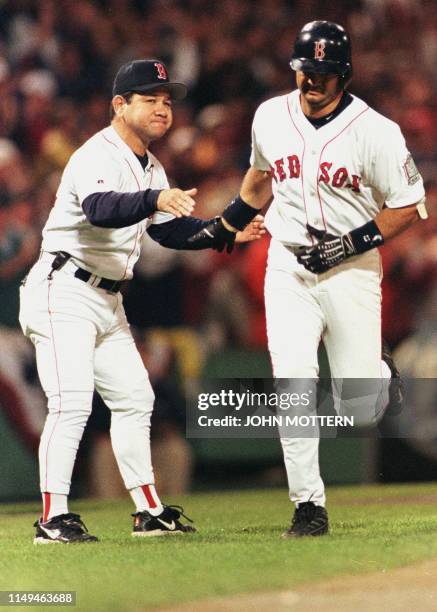 Third base coach Wendell Kim cheers on Boston Red Sox John Valentin as he rounds 3rd after his two run homer in the 1st inning at Fenway Park 10...