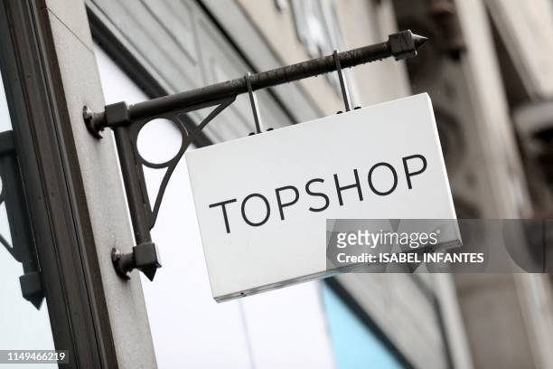 Logo is pictured on a sign outside a Topshop store, operated by Arcadia, in London on June 12, 2019. Landlords and other creditors were on Wednesday...
