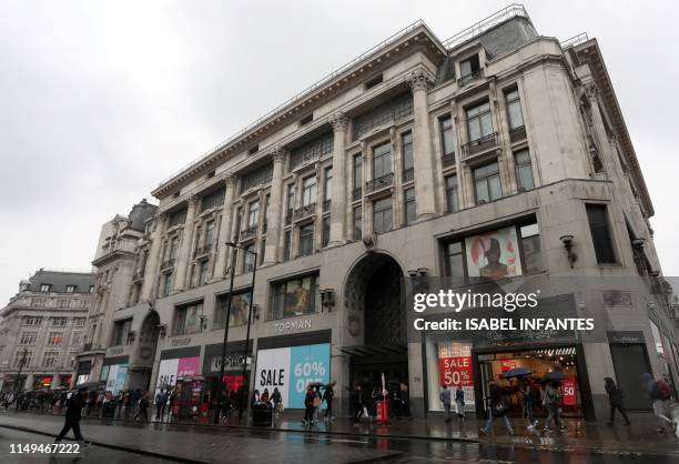 Pedestrians and shoppers walk past the flagship Topshop store, operated by Arcadia, on Oxford Street in London on June 12, 2019. - Landlords and...