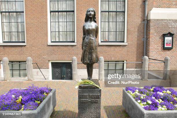 Flowers laid at the Anne Frank statue near Anne Frank house to remember Anne Frank's 90th Birthday on June 12, 2019 in Amsterdam,Netherlands. Today...