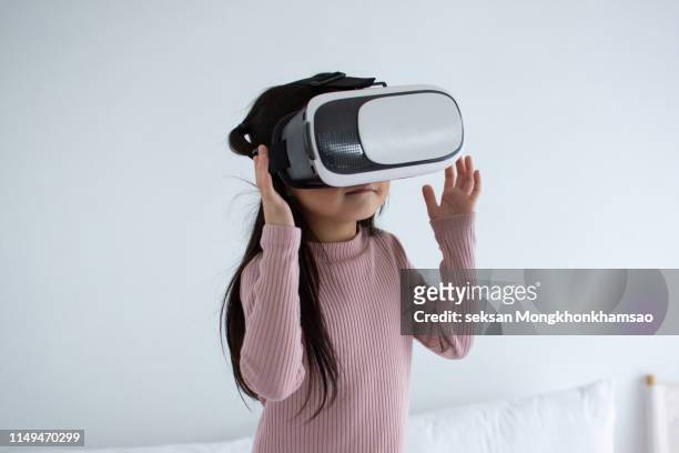 child using virtual reality glasses - vr headset kid stock pictures, royalty-free photos & images