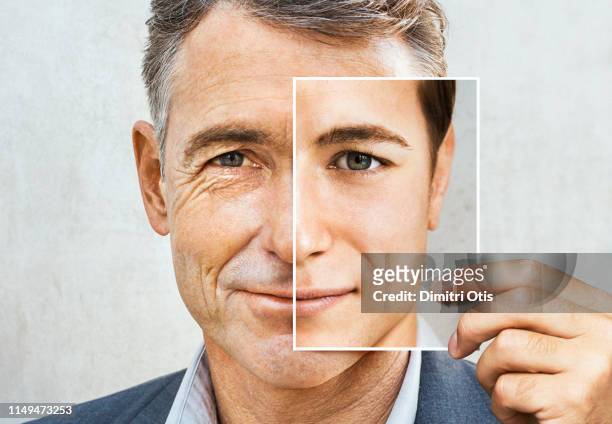 portrait of man holding younger photo of himself - chirurgia plastica foto e immagini stock