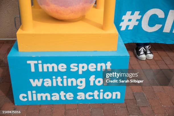 People participate in a demonstration in front of the Democratic National Committee headquarters, during a Greenpeace rally to call for a...