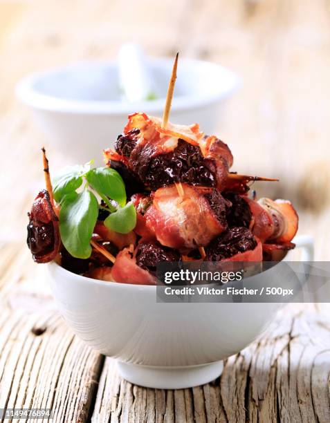 bacon wrapped prunes - dried prunes stock pictures, royalty-free photos & images