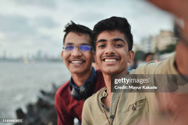 self portrait of two teenager friends - teen indian boy stock pictures, royalty-free photos & images