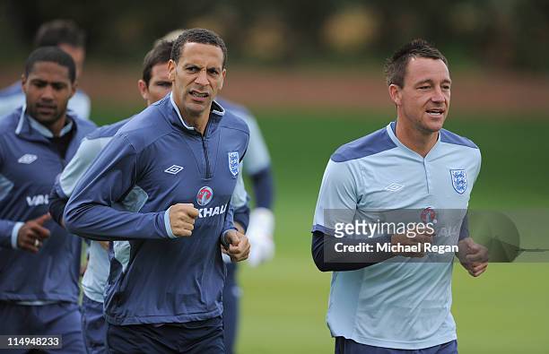 Rio Ferdinand and John Terry warm up during the England training session at London Colney on May 31, 2011 in St Albans, England.