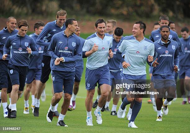 Rio Ferdinand, Frank Lampard and John Terry warm up during the England training session at London Colney on May 31, 2011 in St Albans, England.