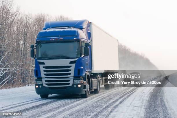 truck on a winter road - diesel trucks stock pictures, royalty-free photos & images