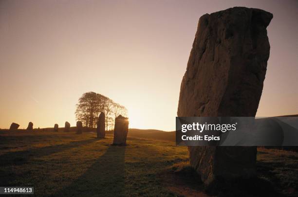 Scenic view at sunset of a stone circle, one of the neolithic henge monuments which is of great importance to pagans, Avebury, Wiltshire, England,...