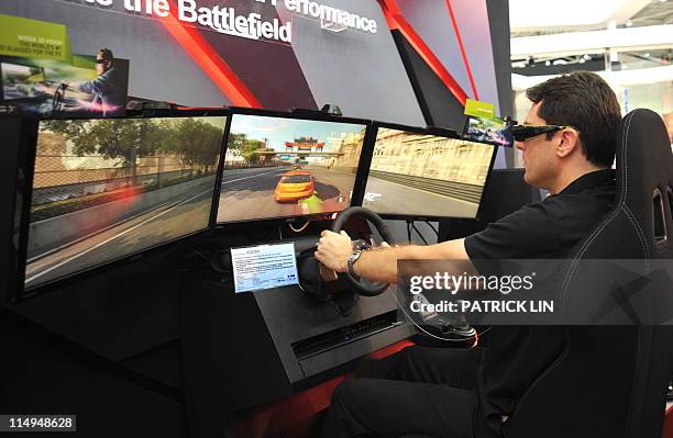 Man wears goggle while playing a three-dimentional game on a gadget developed by AsusTek Computer, Taiwan's leading computer brandname, after the...