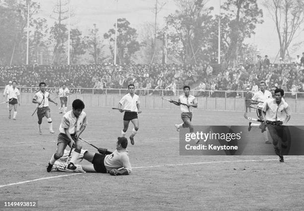 Seiji Kihara of Japan puts the ball past Rainer Stephan the goalkeeper for the United Team of Germany to score a goal during their Men's Olympic...