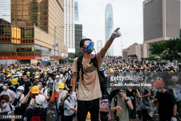 Protester makes a gesture during a protest on June 12, 2019 in Hong Kong China. Large crowds of protesters gathered in central Hong Kong as the city...