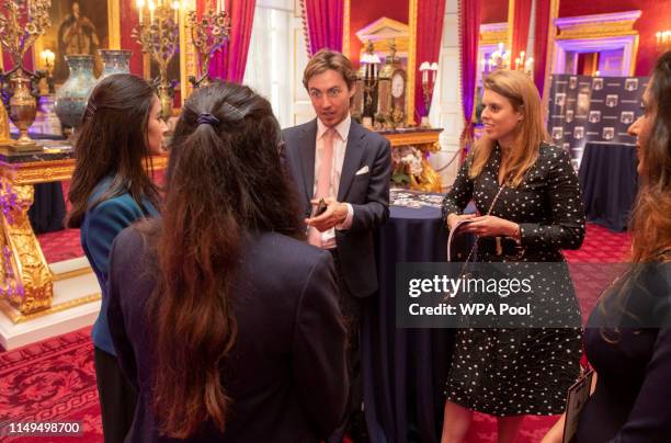 Princess Beatrice of York and her boyfriend Edoardo Mapelli Mozzi speak with guests during a Pitch@Palace event, hosted by Prince Andrew, Duke of...