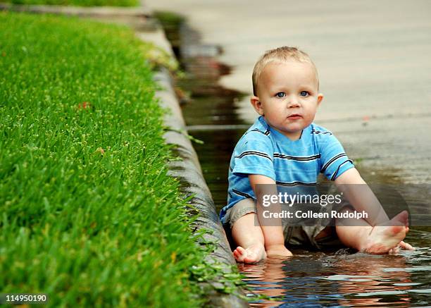 toddler boy sitting in rain - rudolph stock pictures, royalty-free photos & images