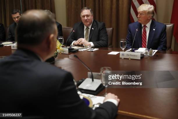 President Donald Trump, right, listens as Mike Pompeo, U.S. Secretary of state, center, speaks during a luncheon with Andrzej Duda, Poland's...