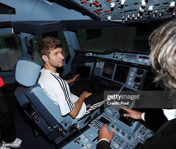 Thomas Mueller of Germany sits in a flight simulator of airbus A380 at the Airport Frankfurt Lufthansa Flight Training Center on May 31, 2011 in...