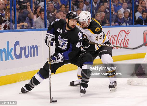 Nate Thompson of the Tampa Bay Lightning controls the puck against Dennis Seidenberg of the Boston Bruins in Game Six of the Eastern Conference...