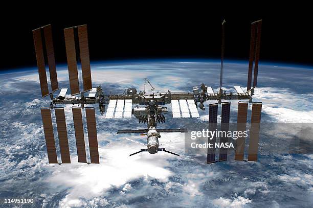 In this handout provided by National Aeronautics and Space Administration , back dropped by planet Earth the International Space Station is seen from...