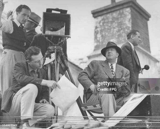 American film director Robert Z Leonard on the set of 'The Firefly', USA, 1937. Left to right: assistant cameramen Harkness Smith and Jimmy Harper,...