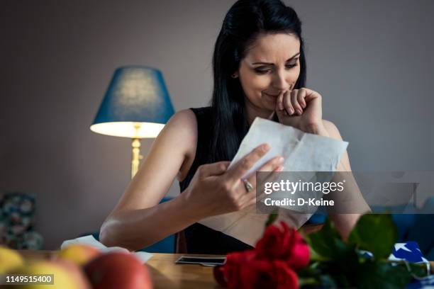 widow reading letter of his fallen husband - military widow stock pictures, royalty-free photos & images