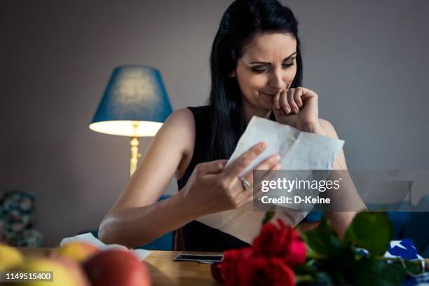 widow reading letter of his fallen husband - crying stock pictures, royalty-free photos & images