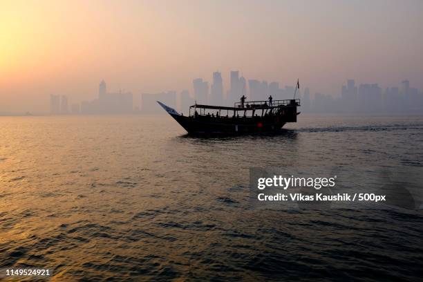 traveling across the sea - dhow qatar stock pictures, royalty-free photos & images