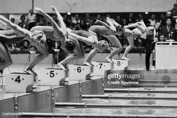 Dawn Fraser of Australia in Lane 4, Sharon Stouder of the United States in Lane 5 and Lynette Bell of Australia in Lane 6 set for the start of the...