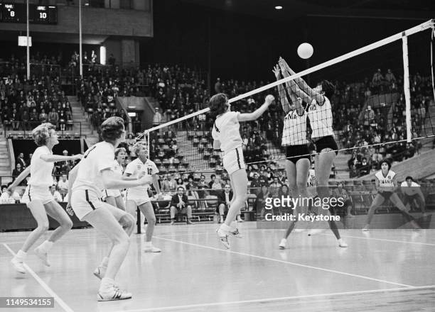 Lou Galloway of the United States attempts to spike the ball against the defence of Rumania during their Women's Olympic Volleyball Tournament match...