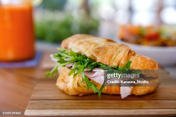 croissant sandwich with ham and arugula - savoury food stock pictures, royalty-free photos & images