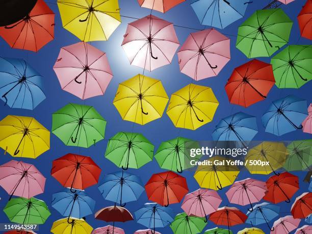 colorful umbrellas in sky - 500px plus stockfoto's en -beelden