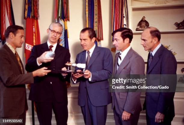 Apollo 16 astronauts John W Young, Charles M Duke, and Thomas K Mattingly, with NASA Administrator Dr James C Fletcher presenting a model of the...