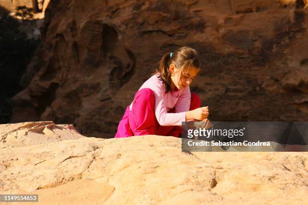 the little girl playing with the sand in the morning on the little petra, jordan. - beautiful arabian girls stock pictures, royalty-free photos & images