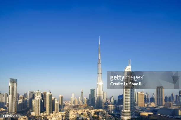 aerial view of city skyline and cityscape at sunset in dubai.uae - dubai financial district stock pictures, royalty-free photos & images