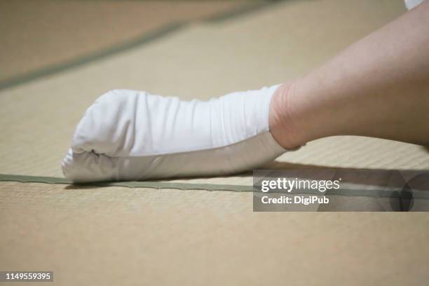 woman's foot wearing tabi sock on tatami mat - washitsu stock pictures, royalty-free photos & images