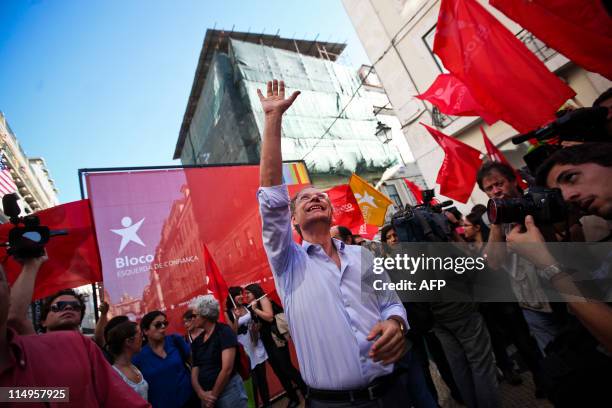 The leader of the left wing Bloco de Esquerda Party Francisco Louca waves to the people as he is mobbed by supporters on May 31, 2011 during a...