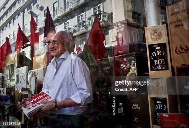 The leader of the left wing Bloco de Esquerda Party Francisco Louca leaves a wine store on May 31, 2011 during a campaign visit in Lisbon ahead of...