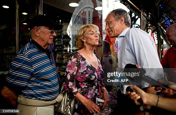 The leader of the left wing Bloco de Esquerda Party Francisco Louca greets people as he is mobbed by supporters on May 31, 2011 during a campaign...